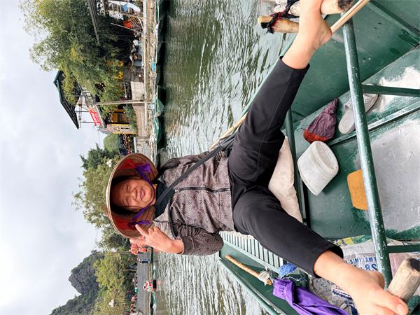 Our guide rows with her feet. 